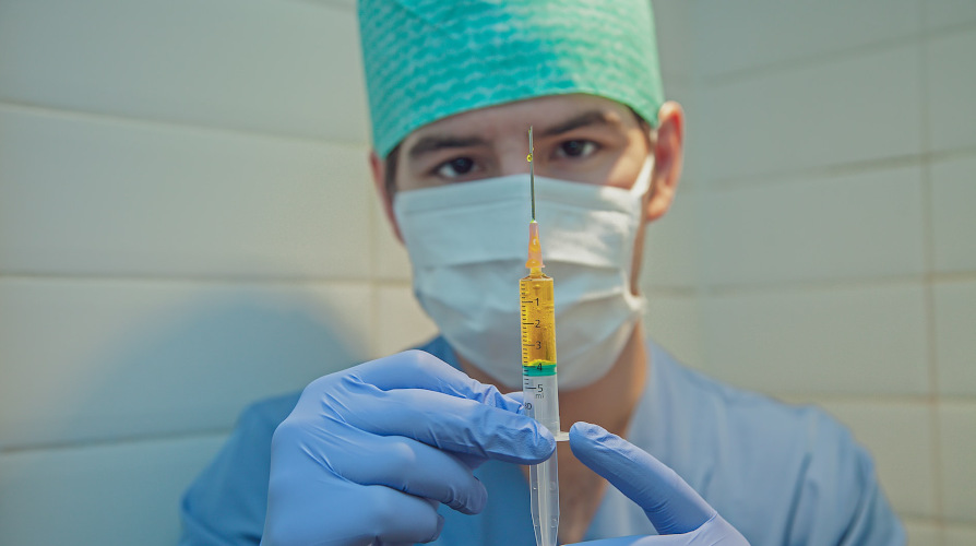 medical doctor holding syringe, multilingual healthcare workers